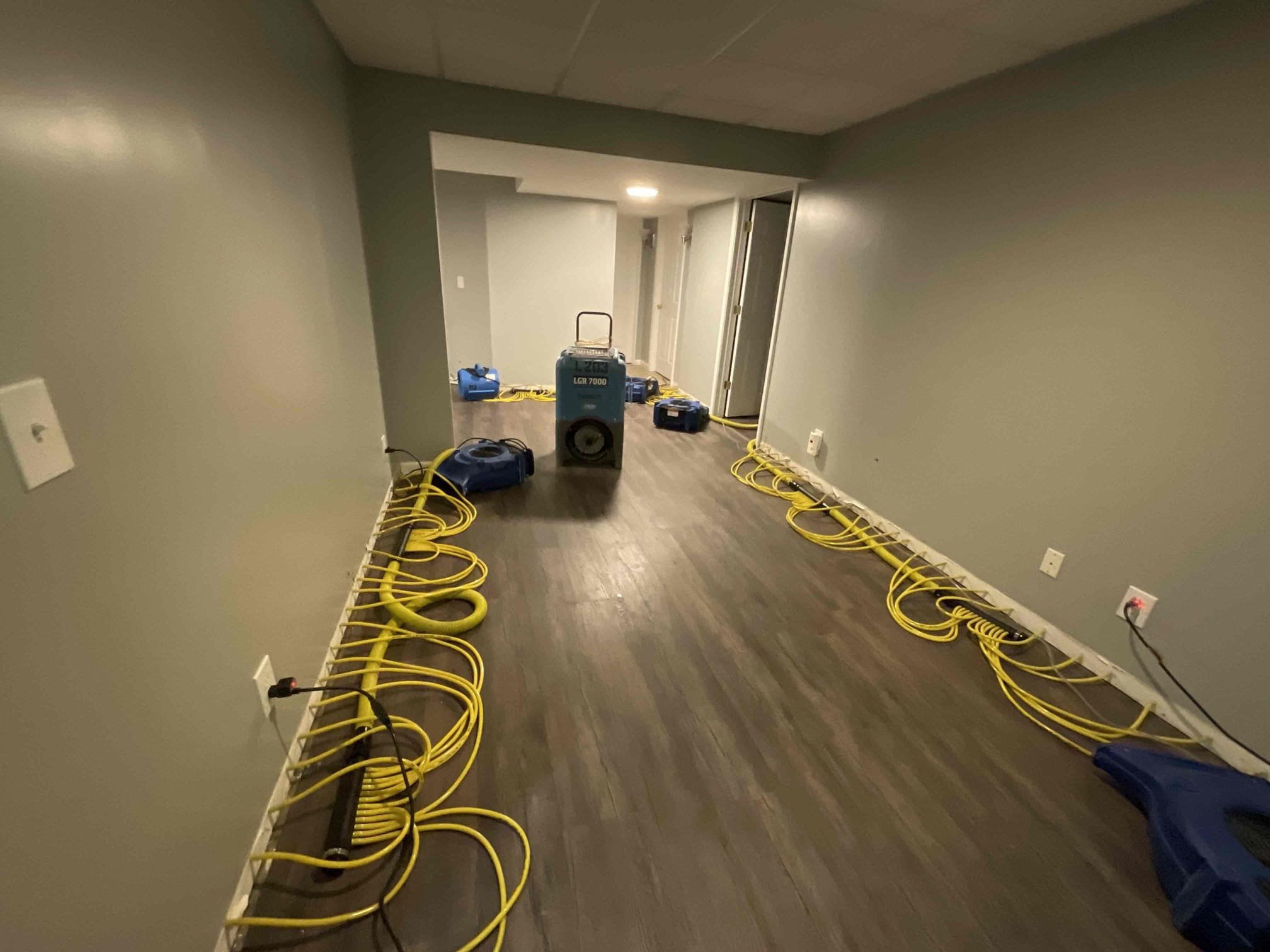 Drying the basement after homeowners experienced a pipe break 